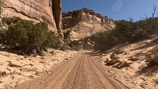 Driving off road dry river Utah desert POV 3. Off road sport and recreation. San Rafael Swell geologic landscape southern Utah. Sandstone rocks into valleys, canyons, gorges and mesas.