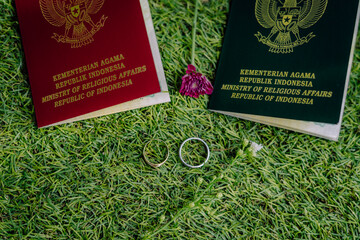 wedding book in Indonesia and wedding rings on synthetic grass
