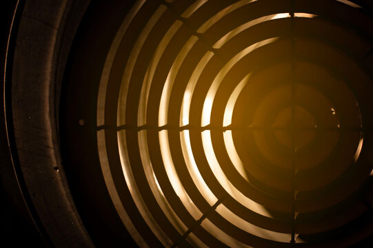 round ventilation grille at night in backlight. front and back background blurred with bokeh effect