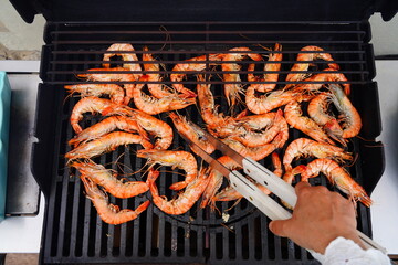 Cooking shrimp on the barbecue grill - 765993976