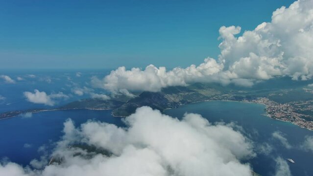 Aerial view on clouds over Kotor Bay, Montenegro. Flying in clouds over sea bay, 4k