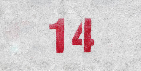 Red Number 14 on the white wall. Spray paint.