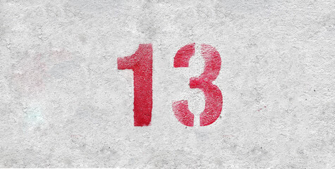 Red Number 13 on the white wall. Spray paint.