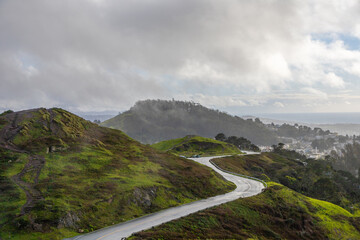 hilly green landscape with a windy road