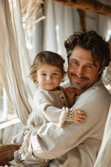 Father embracing a child next to a cradle at home. Love family concept