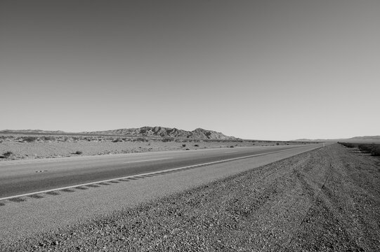 Highway 95 south of Las Vegas, near Boulder City, in the Nevada desert.  Black and white image.