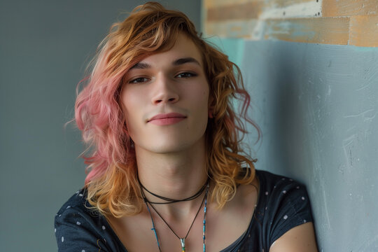 Transsexual woman, a person with gender transition from male to female with dyed hair and on a wall with a gay pride attitude - Powered by Adobe