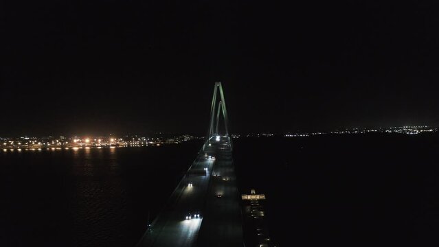 Aerial Panning Shot Of Arthur Ravenel Jr Bridge Over Cooper River Against Clear Sky At Night - Charleston, South Carolina