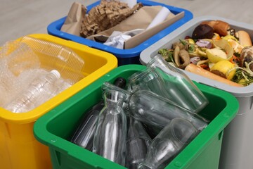 Garbage sorting. Full trash bins for separate waste collection indoors, closeup