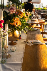 Beautiful and elegant table setting on a hotel rooftop. Flowers, view and elegance.
