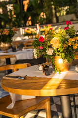Beautiful and elegant table setting on a hotel rooftop. Flowers, sunset and elegance.