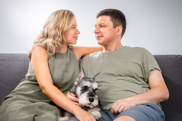Portrait of a married couple with a miniature schnauzer dog
