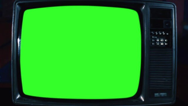 Old Analogue Television Turning On Chroma Key Green Screen. Front Angle View.  You can replace green screen with the footage or picture you want with “Keying” effect in After Effects. 