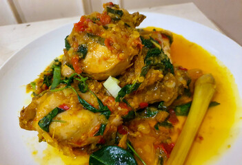 Ayam woku is a traditional dish from the Minahasa or Manado region of Indonesia, made of a chicken cooked mix of herbs and spices, ingredients are lemongrass, turmeric, kaffir lime leaves,
