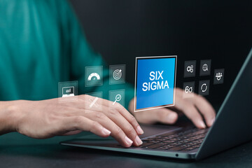 Six Sigma concept. Person using laptop with six sigma icon on virtual screen for manufacturing,...