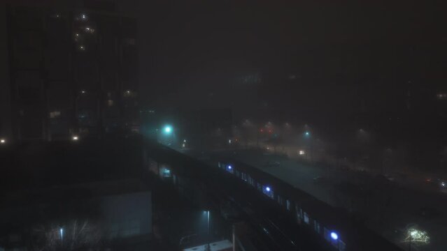 Train passing on Elevated Track at fogy Night. Elements of Subway in downtown Chicago downtown . Wide shot