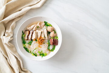 Vietnamese Rice Noodles Soup with Vietnamese Sausage served vegetables and crispy onion