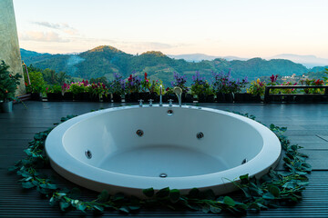 bath tub on balcony with mountain hill background