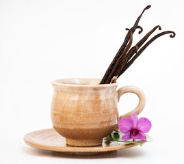 Vanilla pods in coffee cup isolated on white background.