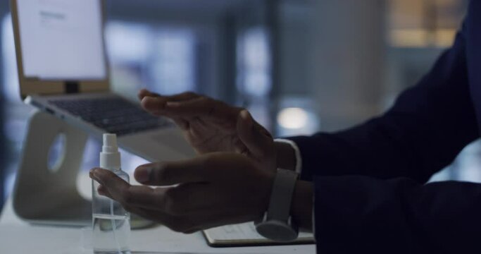 Businessman, hands, and laptop with sanitizer at night for disinfection, spray or hygiene at office. Closeup of male person with bottle cleaner for bacteria, germ removal or late evening at workplace