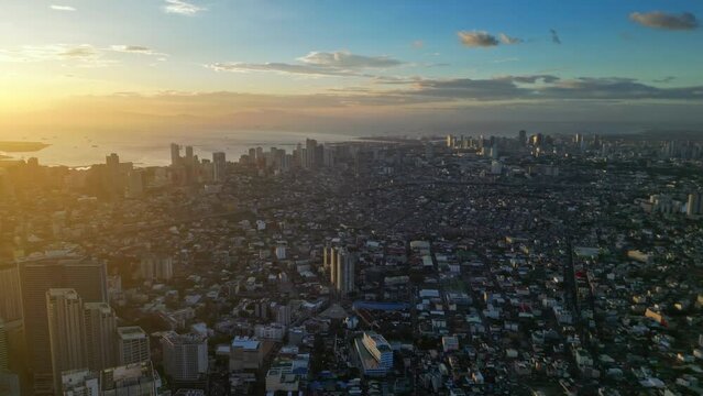 Aerial view of skyscrapers buildings in Makati business district and Manila city at sunset, capital of Philippines, panorama 4k