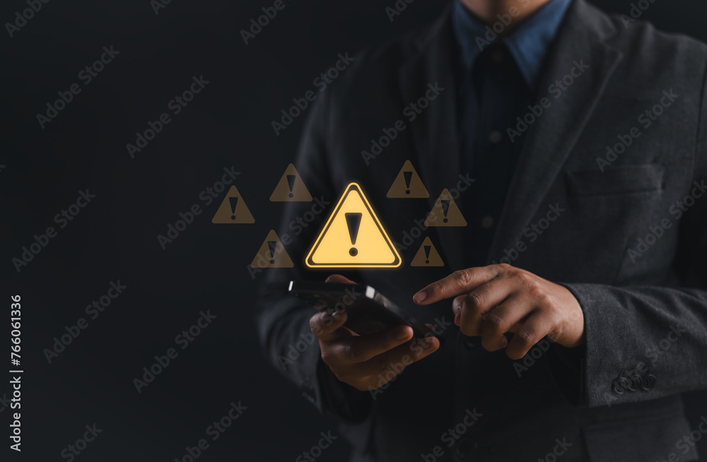Poster System hacked warning alert. Businessman use smartphone with warning sign for cyber attack. Ransomware, Virus, Spyware, Malware or Malicious software, Data breach, Cyber security and cybercrime.