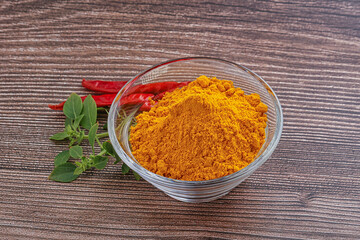 Yellow vibrant curcuma powder in the bowl