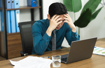 Image of Asian male businessman working in the office