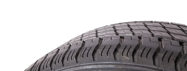 A spare tire for summer tires for seasonal car repairs in a car service. Part of a wheel on a white...