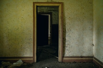 door way and grimey walls in Interior of destroyed abandoned house. Gisborne District, New Zealand.