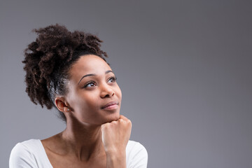 Pensive beauty gazes aloft, curls naturally upstyled