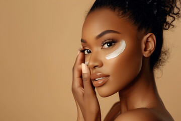A woman with a tan complexion is applying makeup to her face. She has a confident and beautiful expression on her face - obrazy, fototapety, plakaty
