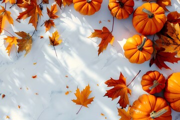 A creative fall collage with different shapes and textures of orange pumpkins and fall leaves 