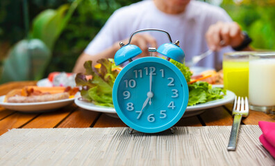 Alarm clock with IF (Intermittent Fasting) 16 and 8 diet rule and weight loss concept.-Diet plan concept - obrazy, fototapety, plakaty