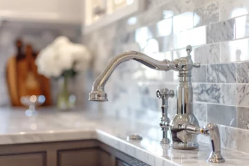 Foto op Canvas A kitchen faucet detail with a marble daisy flower tiled backsplash, white cabinets, chrome faucet, and a light brown quartz countertop © Zoraiz