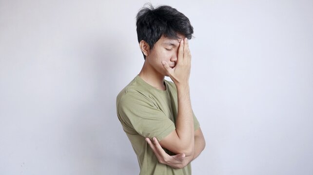 Asian man gesturing dizzily
