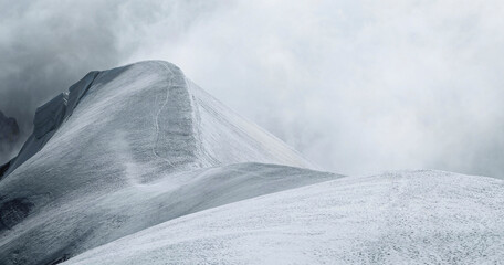 Cloudy snow covered Aiguille du Midi