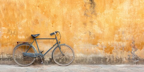 Fototapeta na wymiar Vintage Bicycle Against Textured Yellow Wall