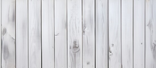 A closeup of a grey rectangular wooden fence with a wood stain finish. The hardwood panels are parallel with a patterned metal font, creating a unique flooring design