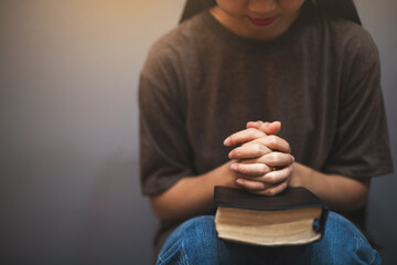A Christian woman was kneeling and praying fervently to God.