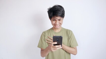 shocked asian man looking at screen on smartphone