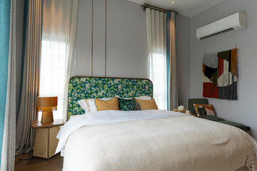 Stylish pale green and white bedroom in the master suite.