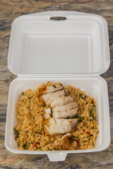 Crispy pork with basil in a foam box