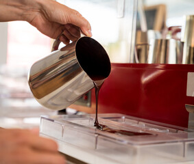 Young woman in the workshop during a lesson on making handmade chocolates and sweets