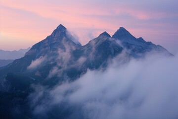 Majestic mountain peaks piercing through a blanket of clouds at dusk with a soft pink sky.
