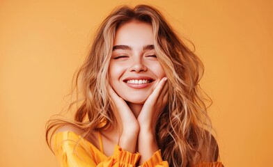 Radiant Young Woman Smiling With Joy Against a Warm Orange Backdrop