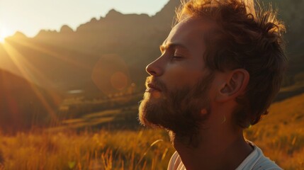Close-up of a man deeply engaged in breathing exercises, set against the backdrop of a majestic mountain range during sunset.