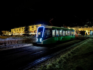 modern tram on the night winter street of the city - 766124304