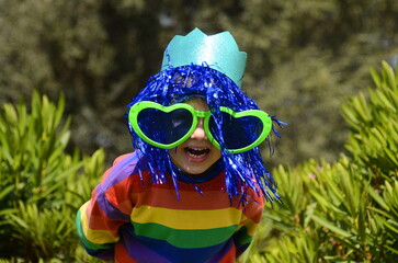 Happy birthday, holiday. Purim, Halloween. Portrait of a 6 year old boy wearing clown glasses and a...