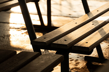 part of wood metal bench with sunlight